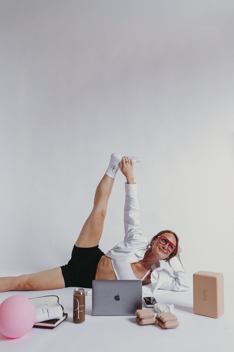 A Daily Form Wellness member stretching, mid-session
